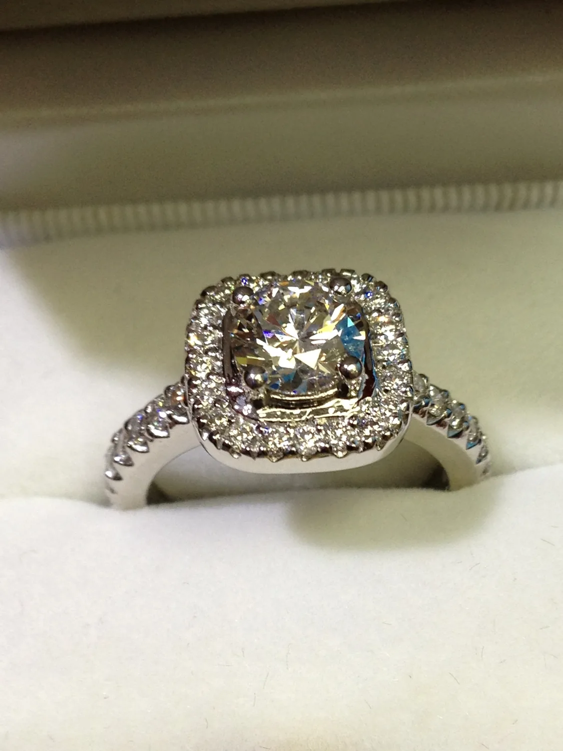 Diamond halo ring in a display case