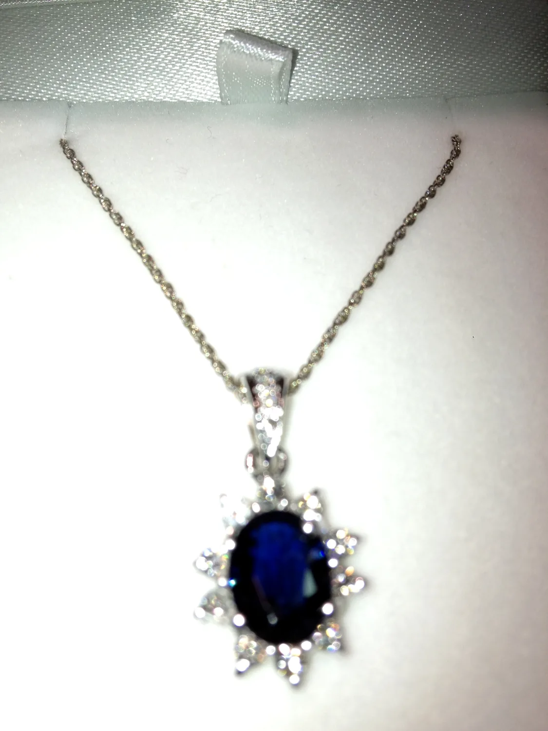 Sapphire pendant suspended from a necklace