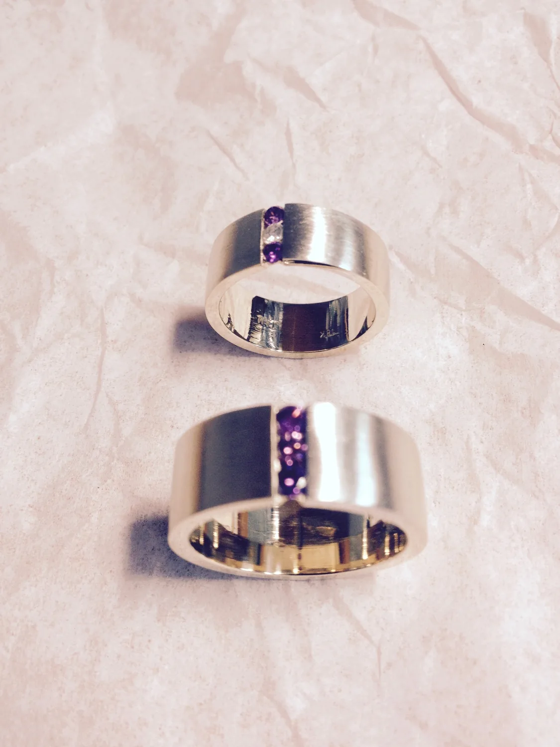 Diamond and gold bands on a pale background